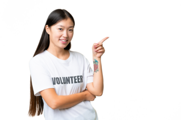 Young volunteer woman over isolated chroma key background pointing finger to the side