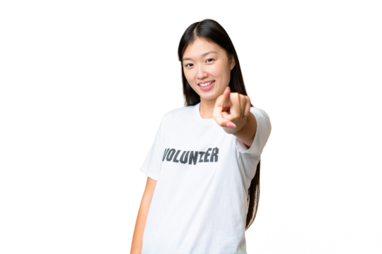 Young volunteer woman over isolated chroma key background pointing front with happy expression
