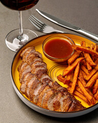 Pork neck steak with sweet potato fries and sauce