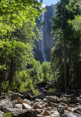 the famous bridalveil fall at Yosemite national park at a sunny summer day. View from the valley up to the cliff