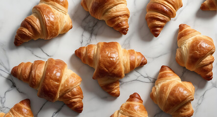 Top view shot of Fresh croissants on a trendy marble table, close up, French breakfast concept
