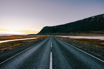 Ring road number 1 in southern Iceland with mountains in the background during sunrise