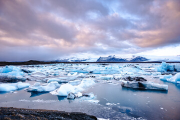 Glacier Lagoon Jokulsarlon with mountains and snow in the background