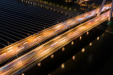 Obraz premium At night, the bridges over the Han River in Wuhan are illuminated by orange street lights.
