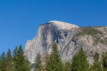 sunny summer day view from below the Yosemite national park to the famous half dome mountain formation , california