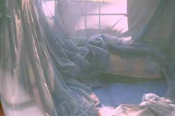Early morning at Vietnam countryside, bedroom filled with sunlight, window view to garden, mosquito...