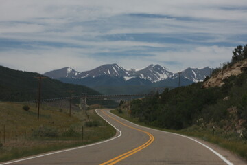 Fototapeta premium the road runs on two sides, near a hillside with mountains
