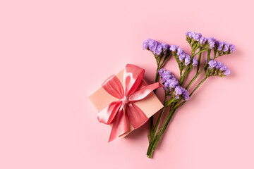 Mothers day background with violet flowers and gift box