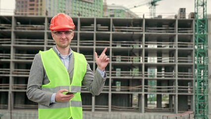 Pleased project manager posing for camera on new development site