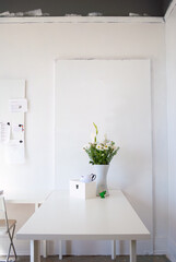 Office Table with a Vase full of flowers.