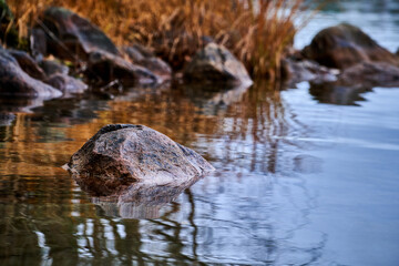 Small rock in the tranquil waters of the river
