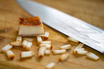 Slices of salo on a wooden cutting board