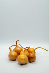 Assorted onion heads arranged on a white background