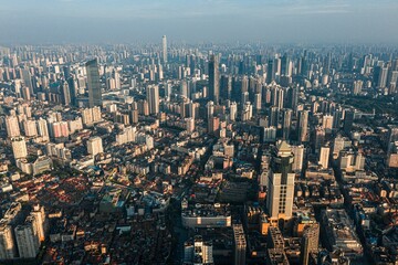The central urban area of Wuhan in the morning light, towering buildings are surrounded by mist.