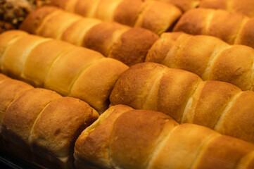 Delicious bread placed on wooden shelves, these breads have exquisite shapes