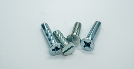 four bolts with hexaconia in each on a white surface