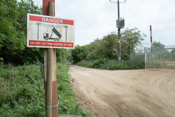 Shallow focus of an industrial warning to HGV lorries when using there tipper to avoid hitting nearby overhead high voltage wires which connects to a nearby village. © Nick Beer
