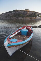 Small boat tied up to a dock in the water