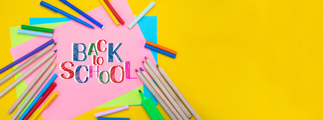 Back to school background. Top view flat lay concept. Childish lettering, colored paper, supplies, stationery for primary school, elementary school or grade school