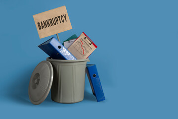 Bankruptcy concept. Trashcan with office supplies