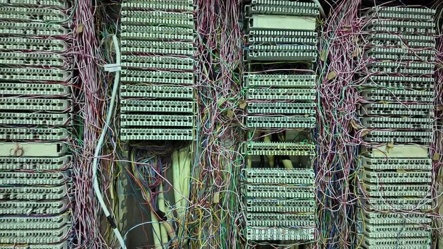 Inside a PABX telephone booth that has a number of connecting cables in many colors in the analog system. communication technology
