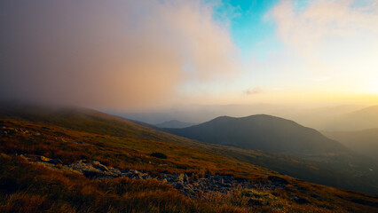 Beautiful sunset in Carpathian mountains in foggy weather , around Shpytsi rocks,  Ukraine