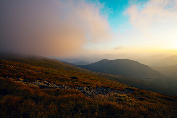 Beautiful sunset in Carpathian mountains in foggy weather , around Shpytsi rocks,  Ukraine