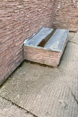 Basement opens in the building of house has window is located below ground level around facing brick. Window is covered with galvanized steel sheet to protect basement from precipitation during rain