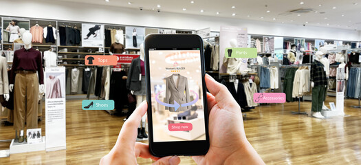 Augmented reality,AR Shopping retail concept.Hands holding mobile phone on blurred fasion store