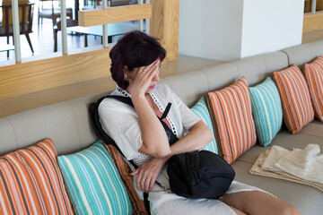A woman is offended by her husband and hides from the camera, not wanting to be photographed.