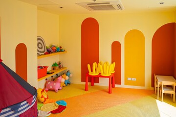 A room with a yellow wall and orange stripes