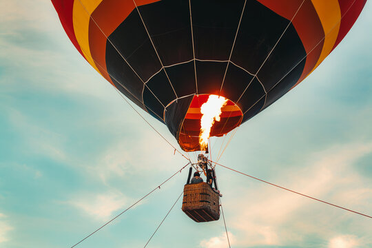 A hot air balloon with a fire in the middle of it
