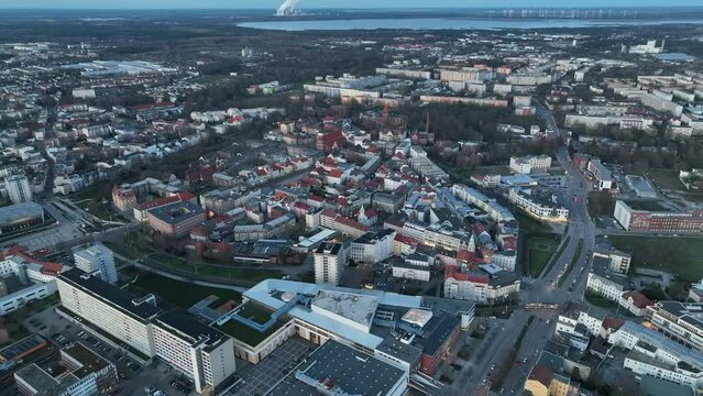 Drone flight above Cottbus city during a blue hour, showing lake in the distant background, Germany