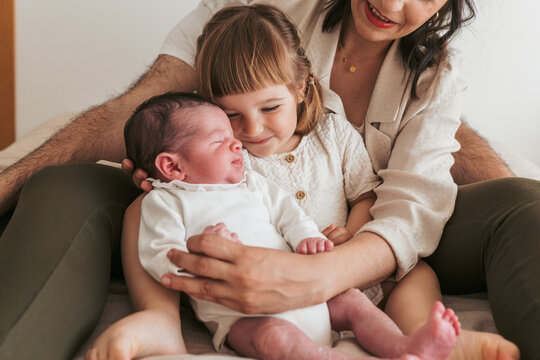 Family welcoming a newborn baby at home
