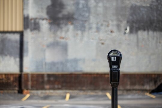Parking meter in a public parking lot with a blurry background