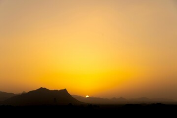 Landscape of rocky mountains during a breathtaking sunset in the evening