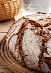 fresh baked bread on wooden table with other foods around it