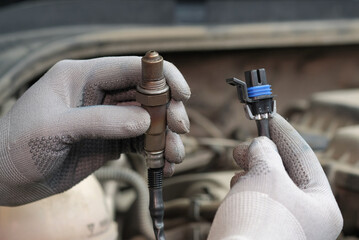 Car parts.The sensor is oxygen.An auto mechanic monitors the serviceability of the new sensor...