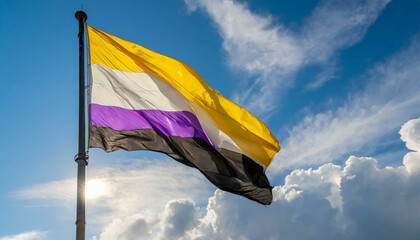 Fototapeta premium non-binary flag flies against the blue sky, lgbt pride month