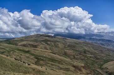 Scenic view of a mountainous landscape with rolling hills covered in clouds