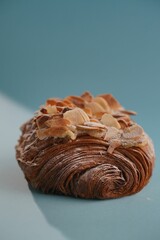 Closeup of a chocolate croissant with almond frosting on the table