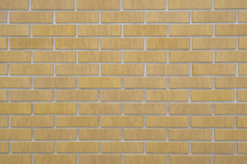 Close-up of a textured yellow brick wall