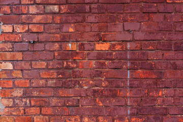 Close-up of a textured old red brick wall