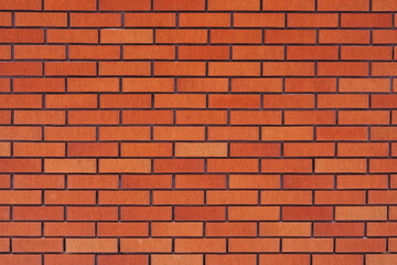 Close-up of a textured orange brick wall