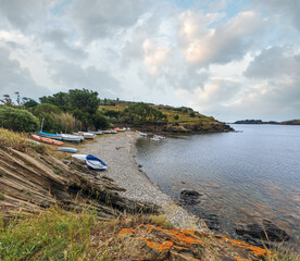 Bay Cala de Portlligat summer view with beach and boats (Cadaques, Girona, Spain).