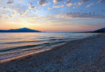 Beautiful summer sea sunset landscape on Borsh beach, Albania. People unrecognizable.