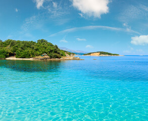 Beautiful Ionian Sea with clear turquoise water and morning summer coast view from beach (Ksamil, Albania).