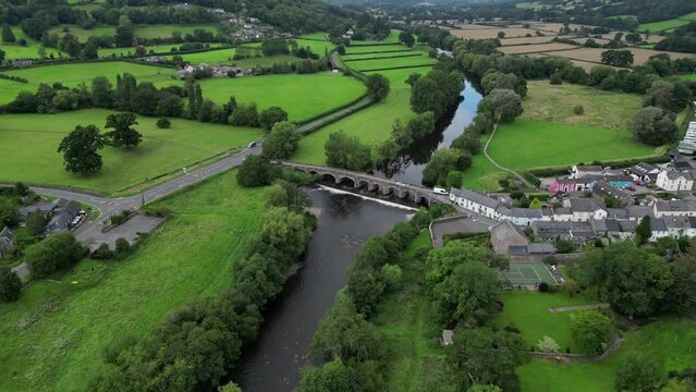 Aerial footage of the Crickhowell Bridge spans the River Usk and the cityscape of Crickhowell , UK
