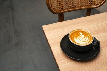 A cup of hot latte coffee on the table for breakfast
