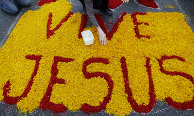 People build a rug with religious images during Corpus Christi celebrations in Santana de Parnaiba,...